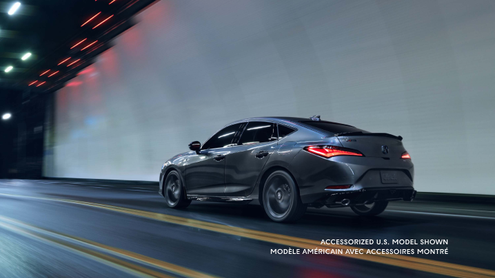 Rear left side angle of Integra in motion in dark tunnel