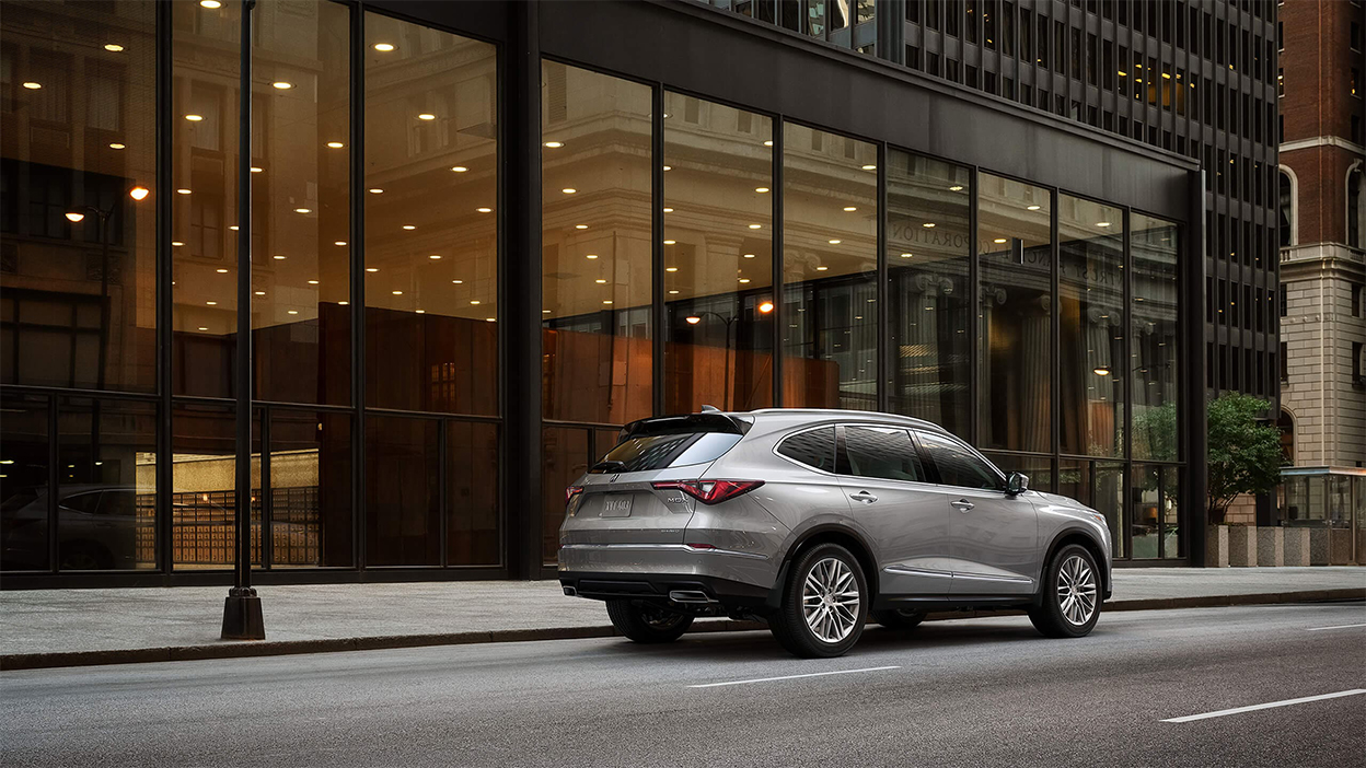 A grey MDX parked on a city street.