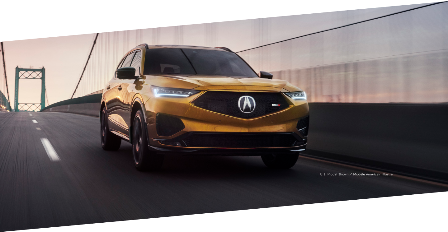 3/4 view of a MDX Type S driving over a bridge.