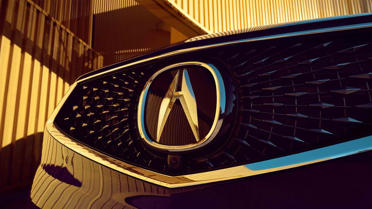 3/4 front view of RDX grille and Acura emblem.