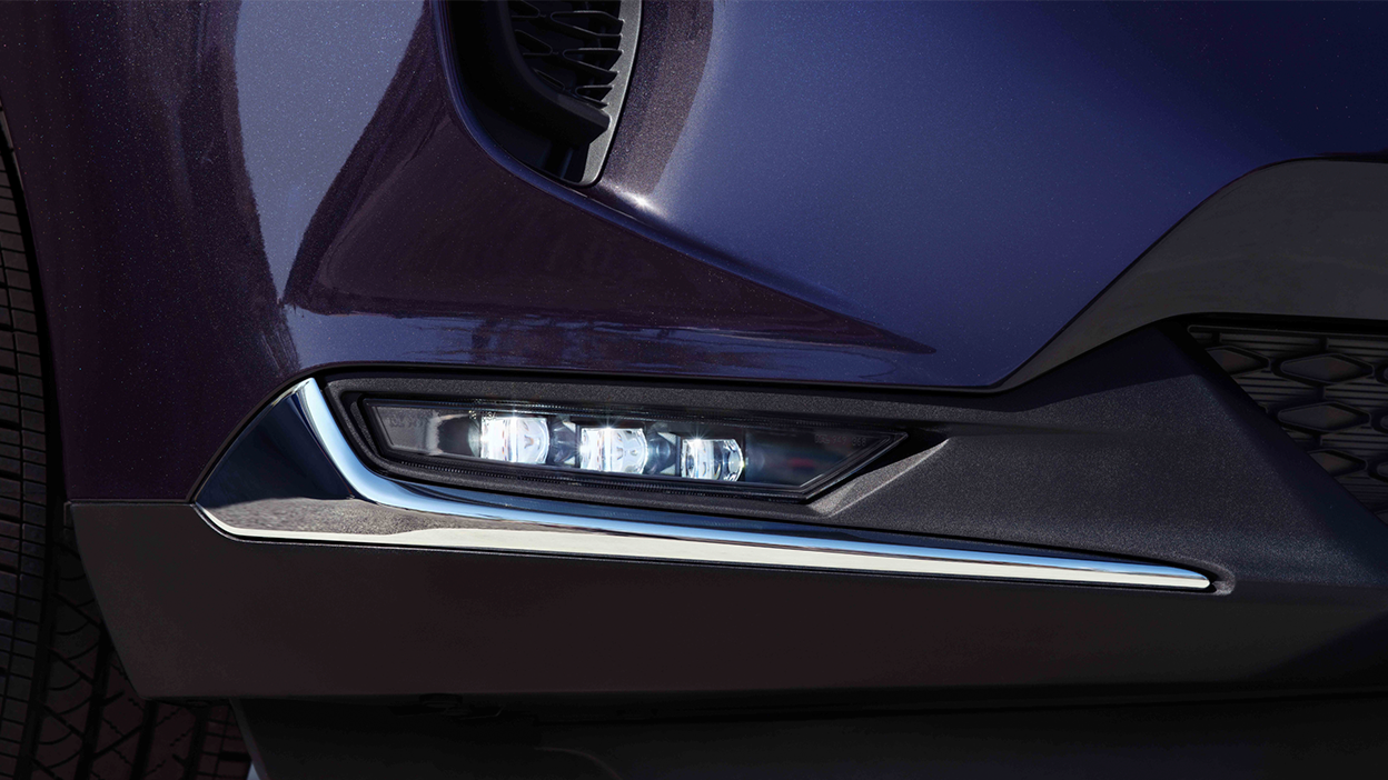 Macro close up of front fog light on blue RDX.