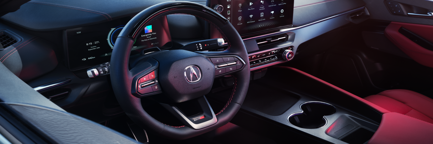 Closeup of steering wheel and driver’s side of the cockpit.