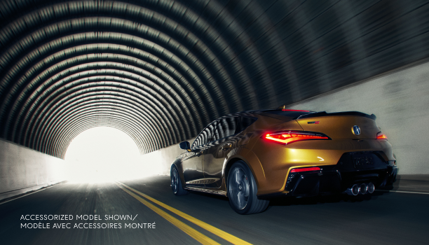 Rear left side angle of Integra in motion in dark tunnel