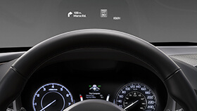 Close up for an Acura’s steering wheel and Heads Up Display. / Un gros plan du volant d’une Acura avec affichage tête haute. 